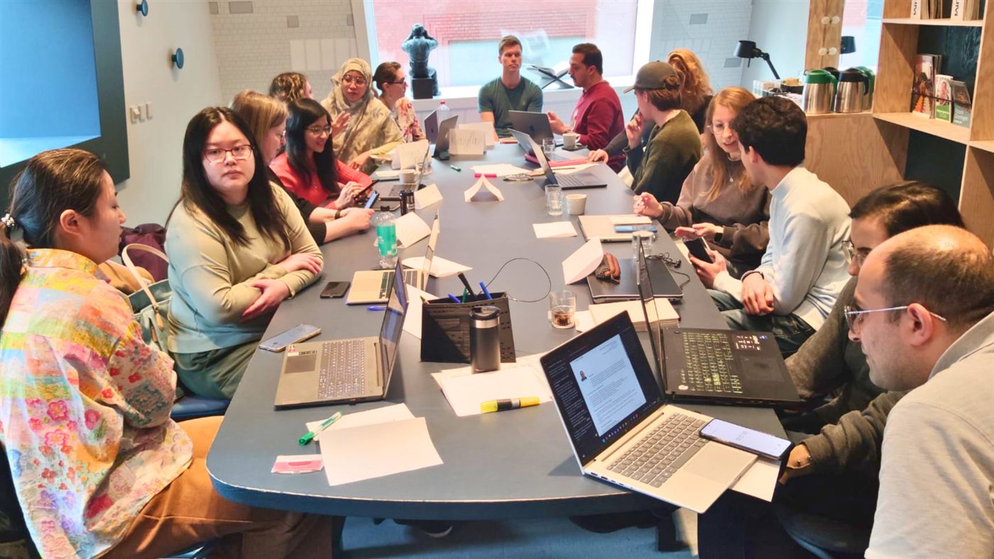 International participants gathered around a table